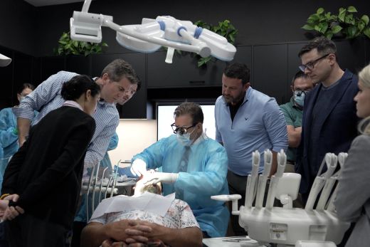 Course attendees around the operatory during live surgery at OsseoPure HQ.