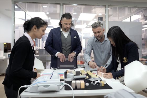 Valdi Blaszak with the OsseoPure lab team reviewing a case at the bench